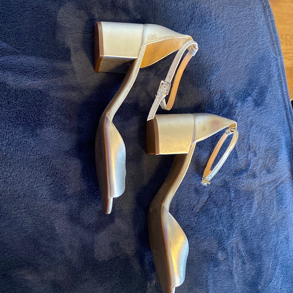 Beautiful, silver leather shoes,9B, brand new. Small scratch on right shoe.